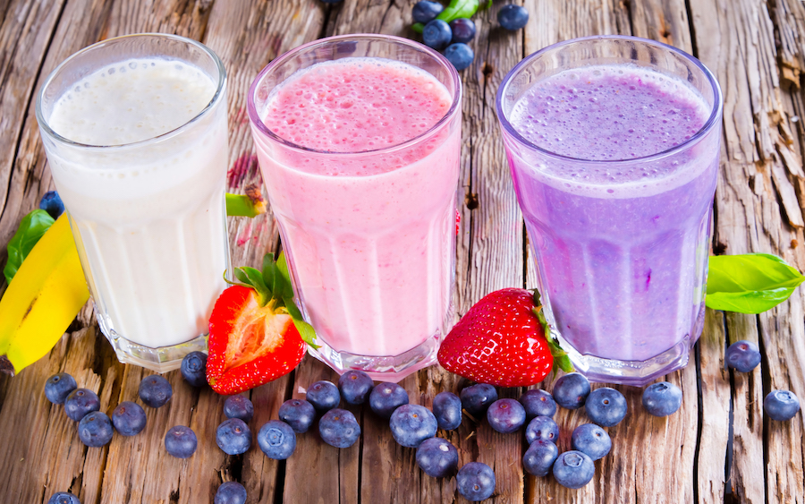 glasses of berry cocktails and a metal shaker. Drinks with mint and blackberries Fitshakes